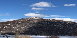 An image of a Colorado winter mountain against the blue sky.